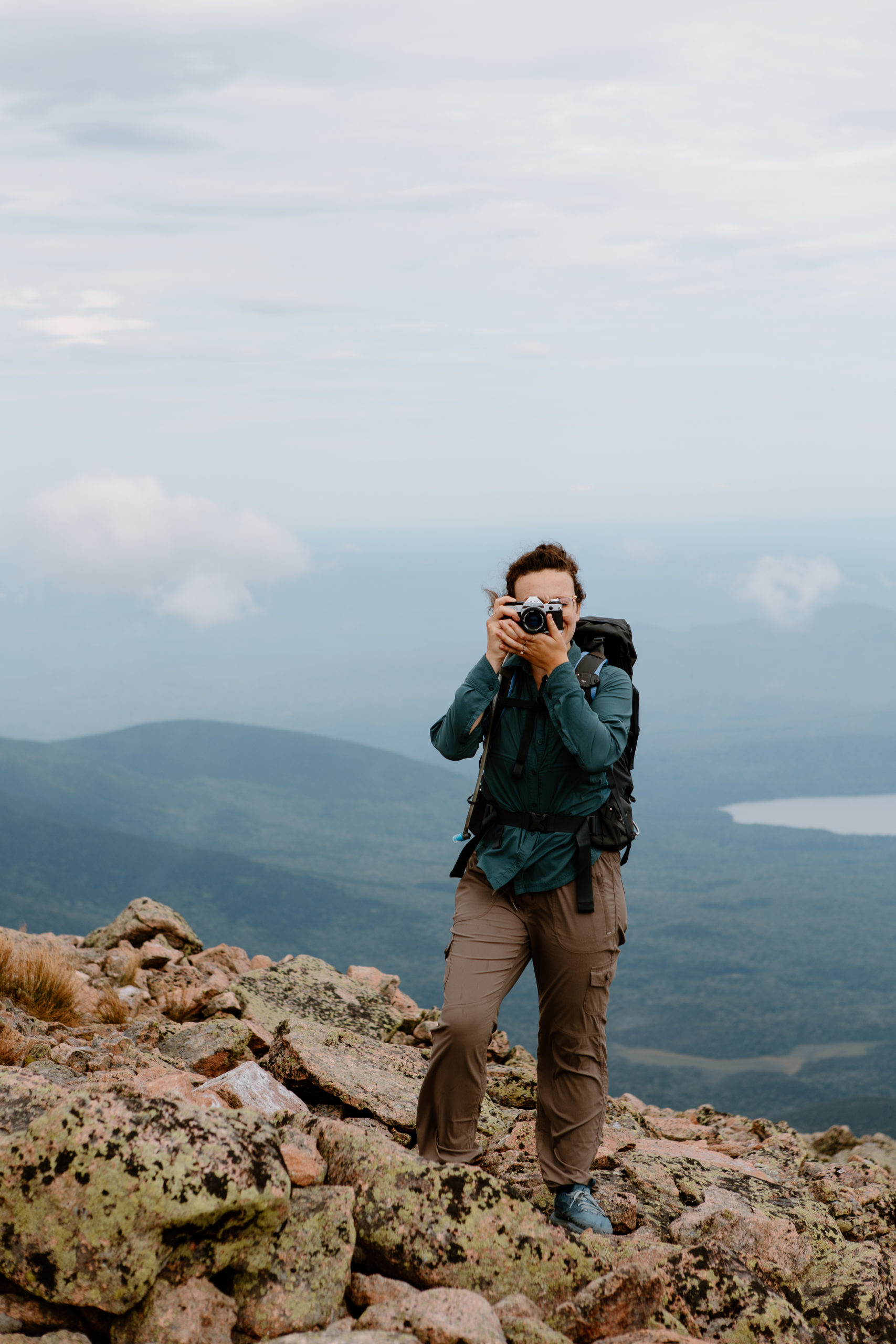Hiker taking photo on Mount Katahdin Maine
