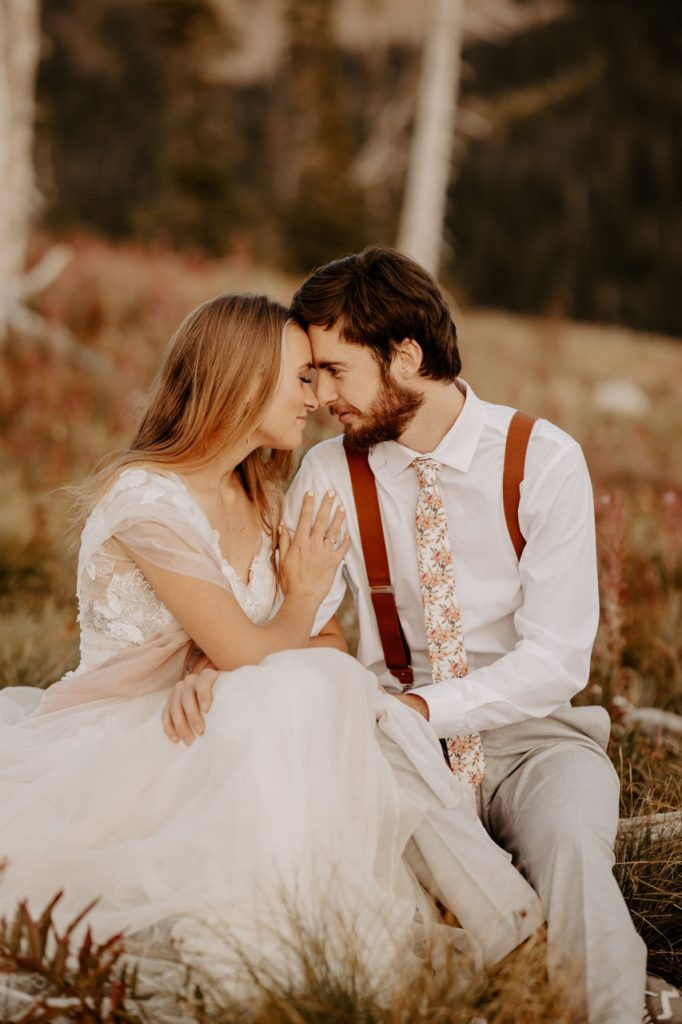 couple in mountains in wedding attire
