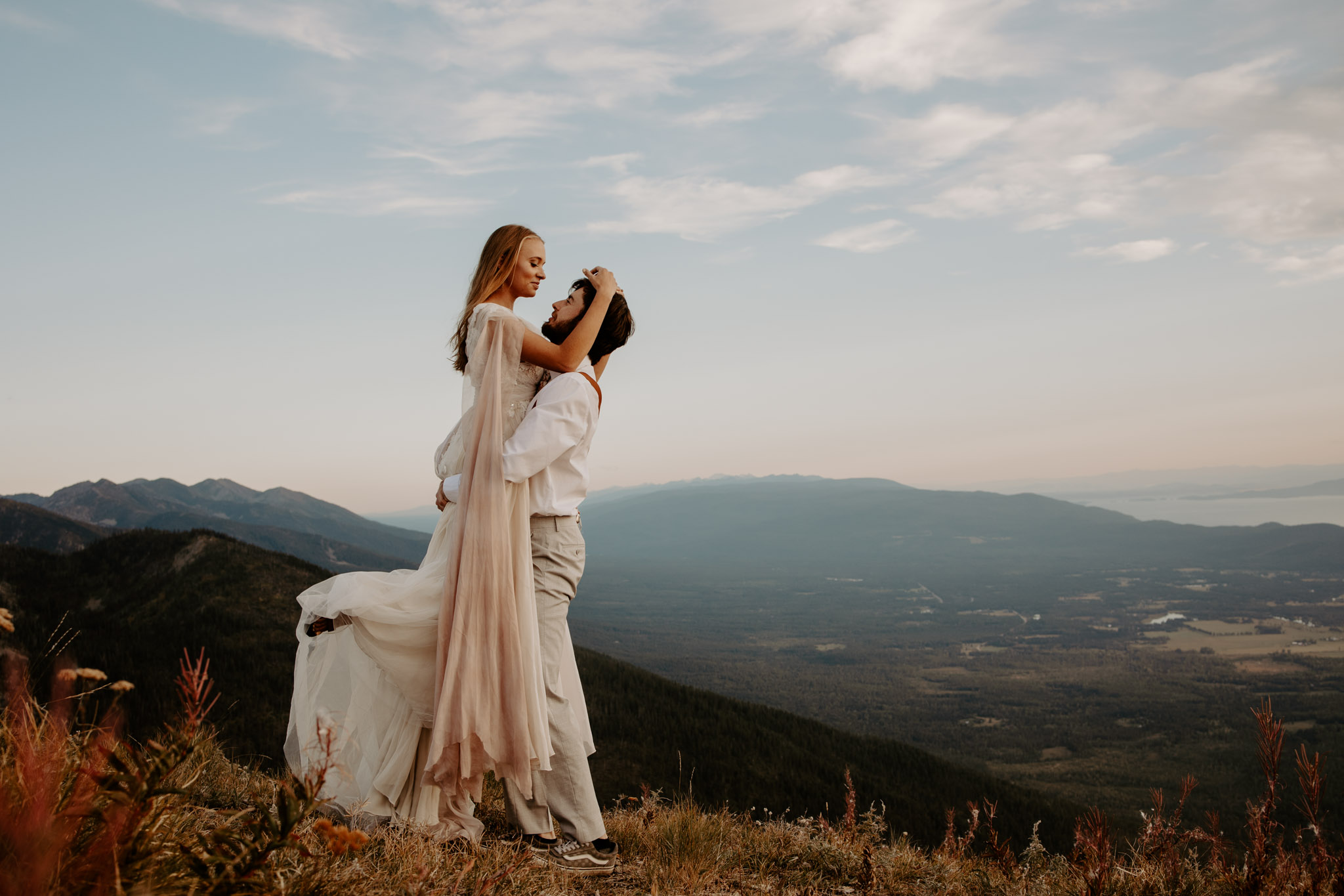 couple in mountains in wedding attire