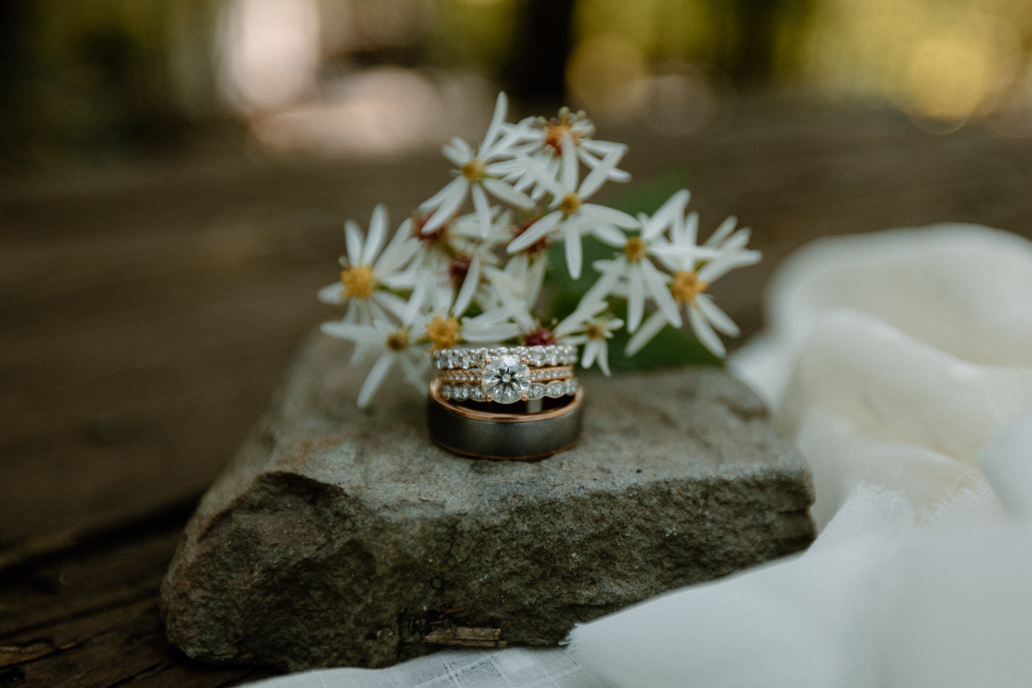 wedding ring details and flowers and rocks
