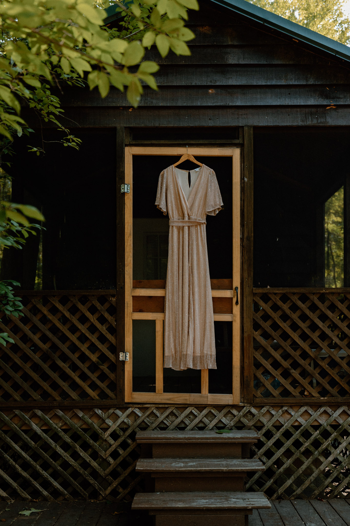 wedding dress hanging on campground cabin