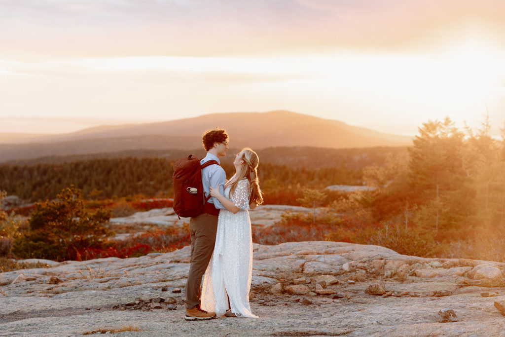 couple hiking at sunset in Acadia Maine