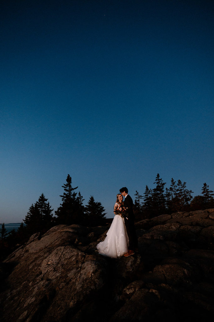 couple hugging watching the sunrise in Acadia National Park 