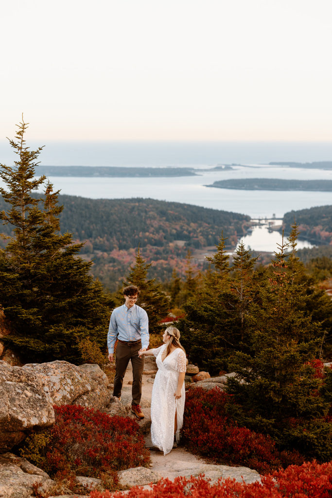 couple hiking in wedding attire Acadia National Park